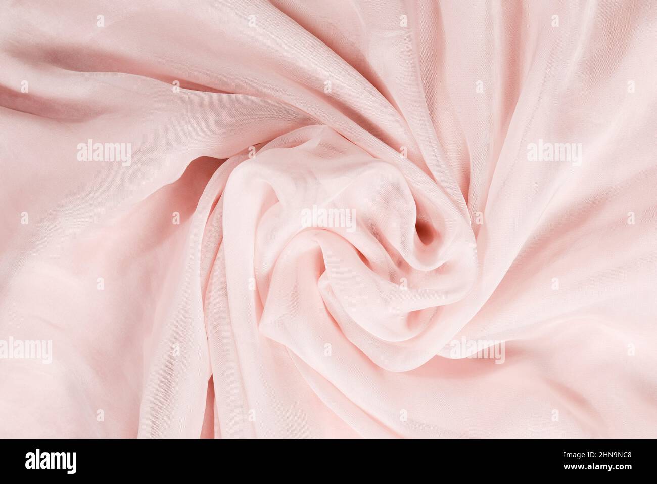 Soft smooth pink silk fabric background. Fabric texture. Stock Photo