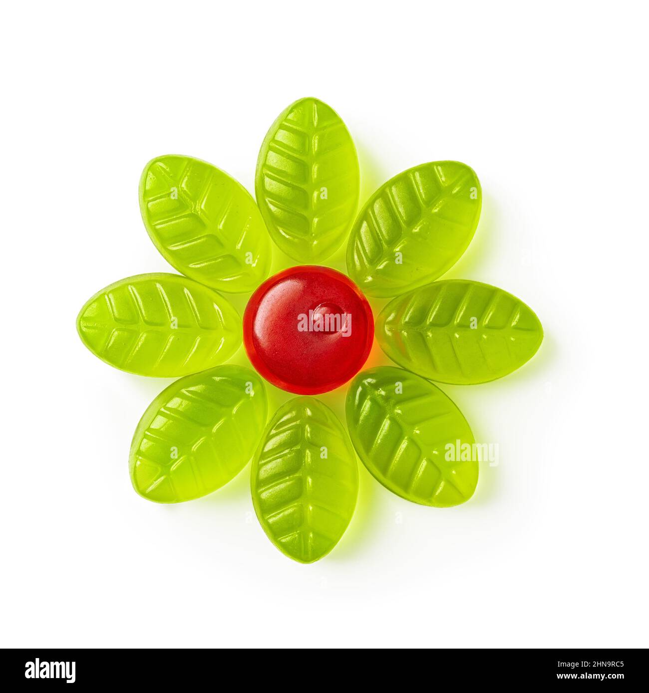Chewy candy flower of red green colors isolated on a white background. Tasty gummy sweets