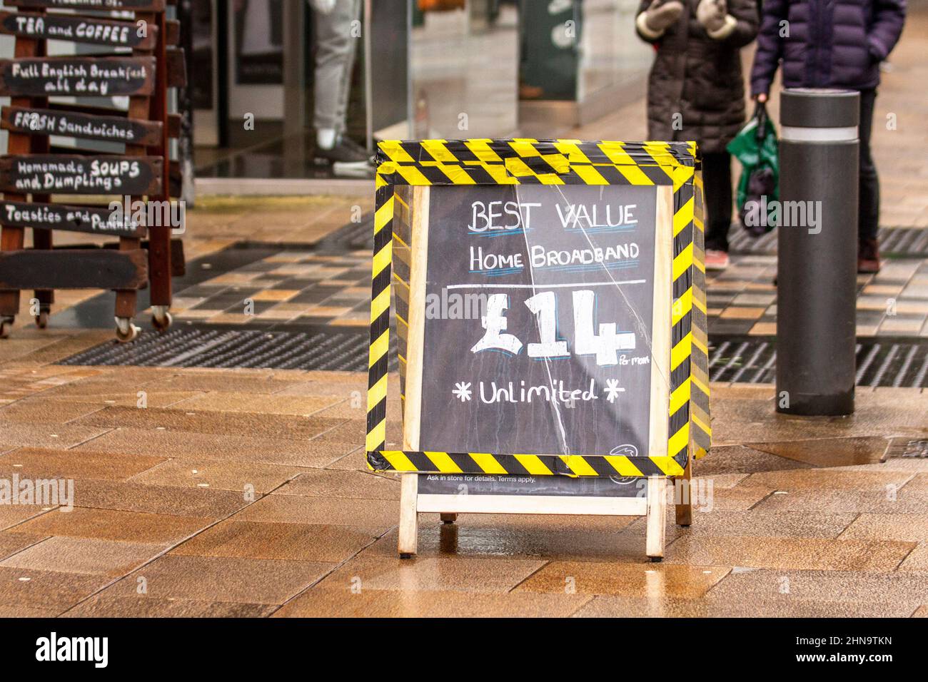 Best Value Home broadband £14 unlimited pavement hazard sign outside Three mobile phone shop in Preston, UK Stock Photo