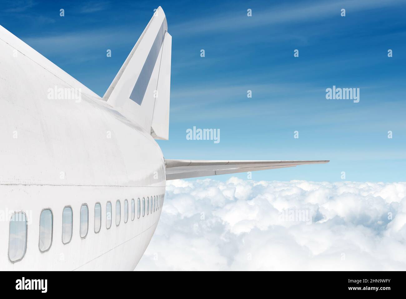 big jet plane fuselage view above the clouds Stock Photo