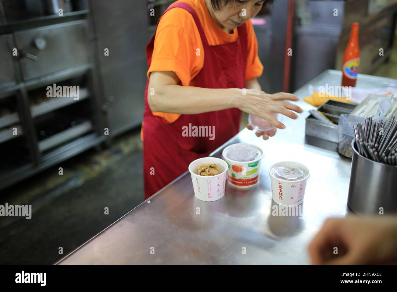 Taiwanese woman make food in kitchen Stock Photo