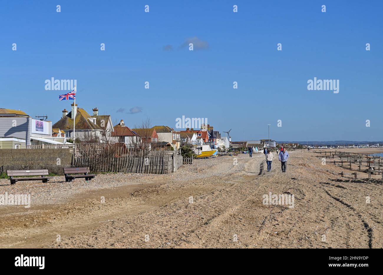 Pevensey Bay Views East Sussex England UK Walkers on the beach with