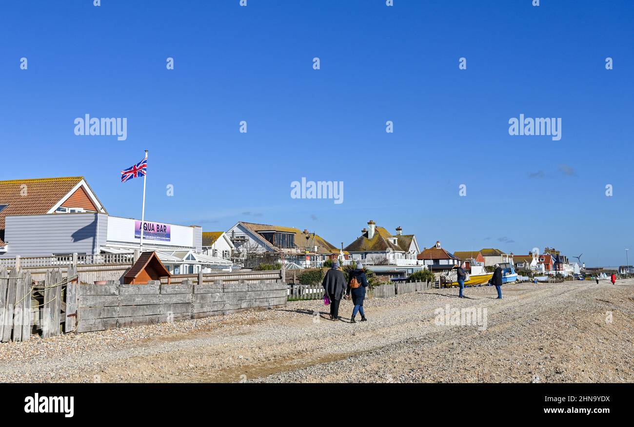 Pevensey Bay Views East Sussex England UK Walkers on the beach with