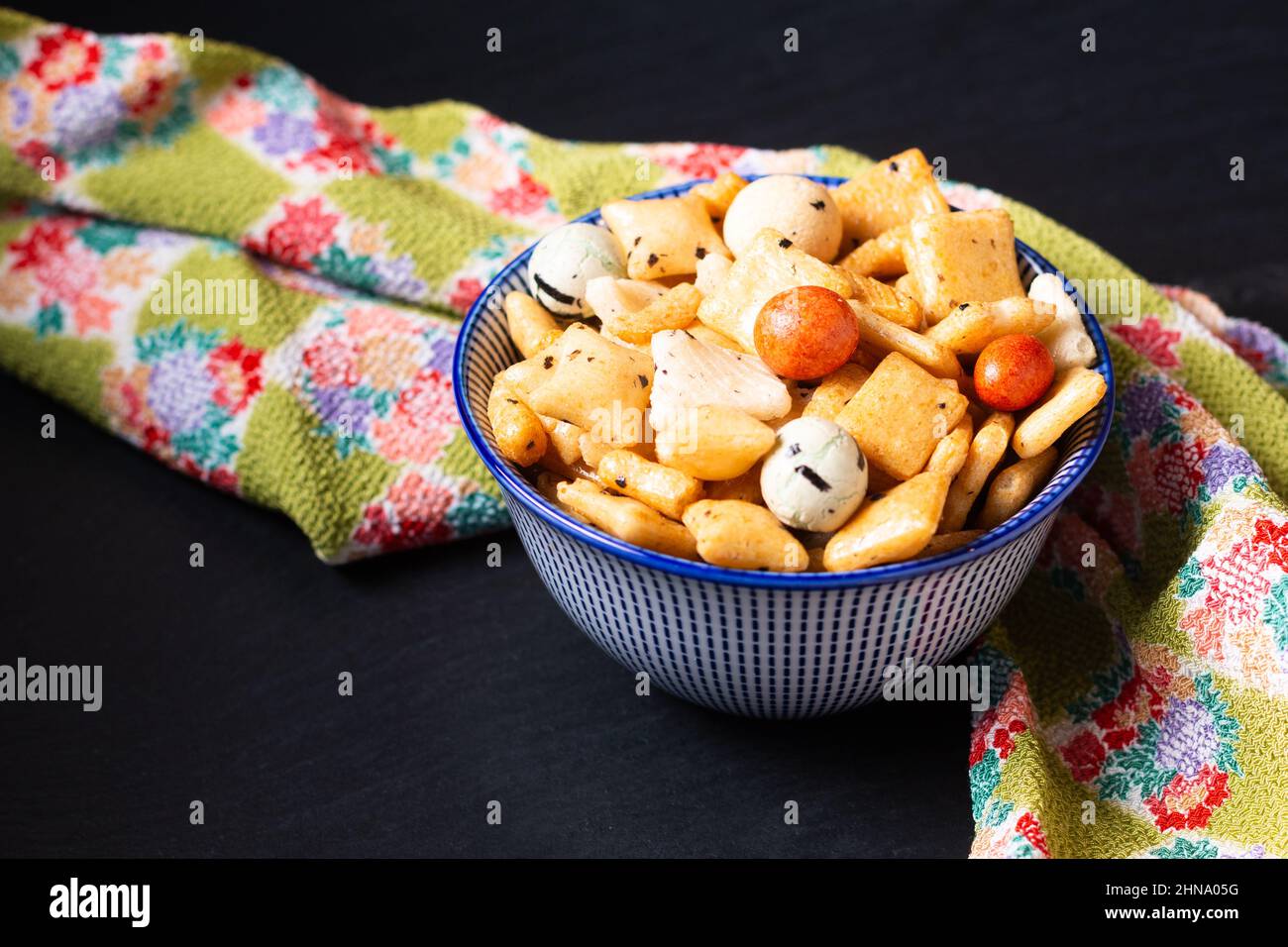 Food concept Senbei Japanese snack rice crackers on wooden board with copy space Stock Photo