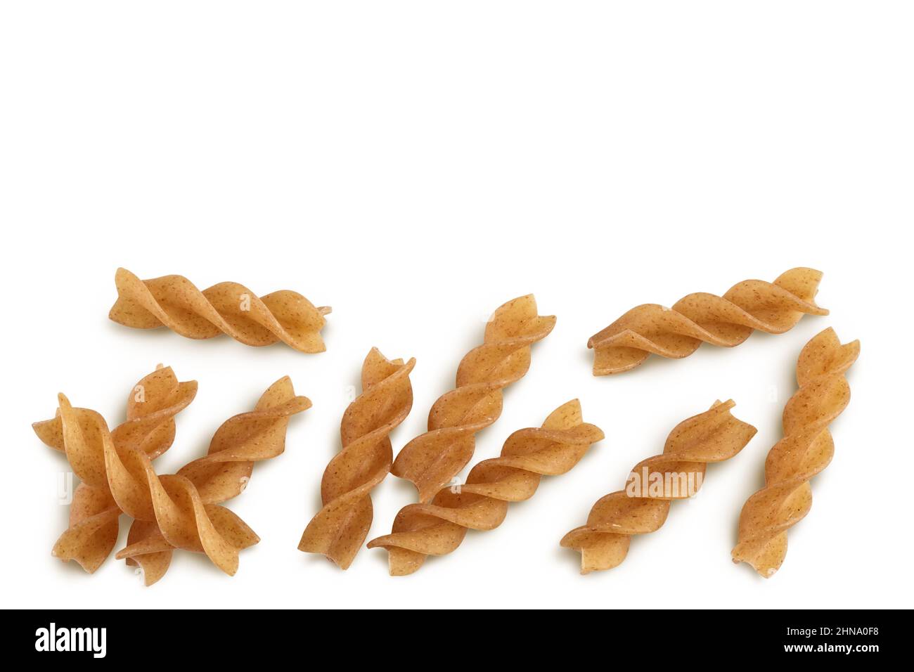 Wolegrain fusilli pasta from durum wheat isolated on white background with clipping path and full depth of field. Top view. Flat lay. Stock Photo