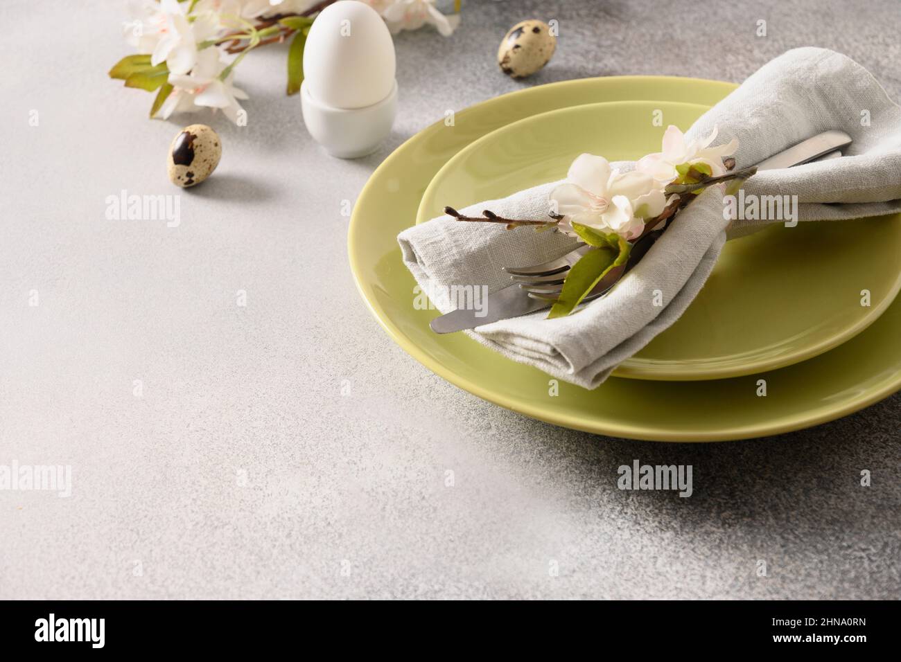Easter festive table setting and spring decorations on gray background. Close up. Template Easter Buffet Menu. Stock Photo