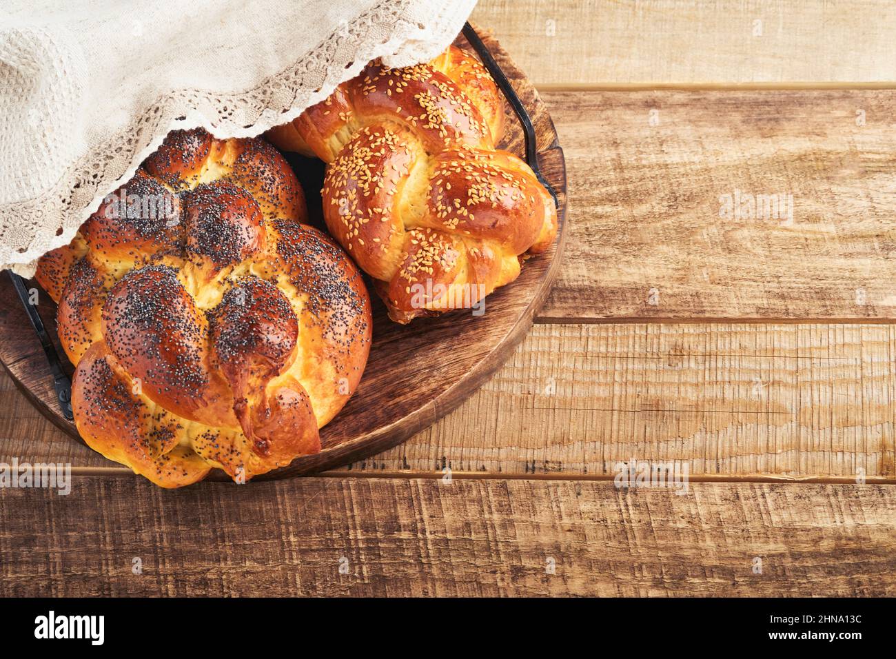 Shabbat Shalom. Bread challah with sesame seeds and poppy seeds on