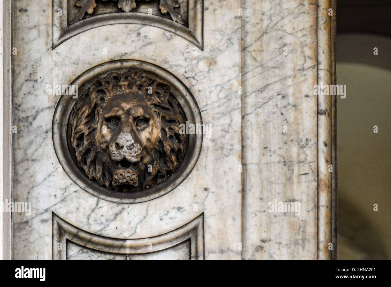 Close-up of a door frame with a marble bas-relief depicting a lion's head, Turin, Piedmont, Italy Stock Photo
