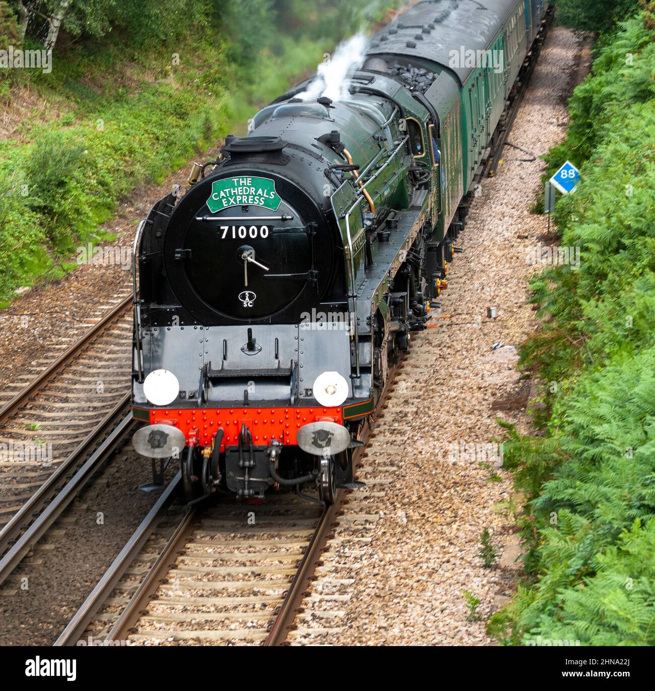 The Cathedral Express BR Standard Class 8 Pacific steam locomotive 71000 Duke Of Gloucester steaming through the New Forest, Hampshire, England, UK Stock Photo