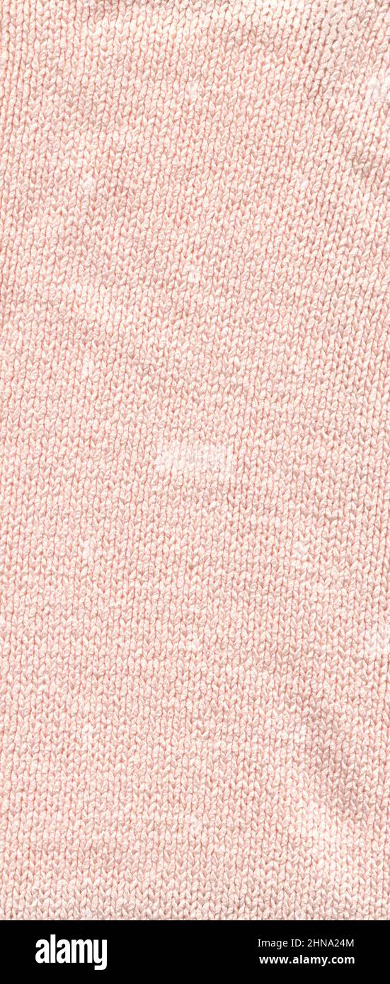 Knitwear beige wool sweater texture close up.  Warm beige fabric sweater made of wool. Stock Photo