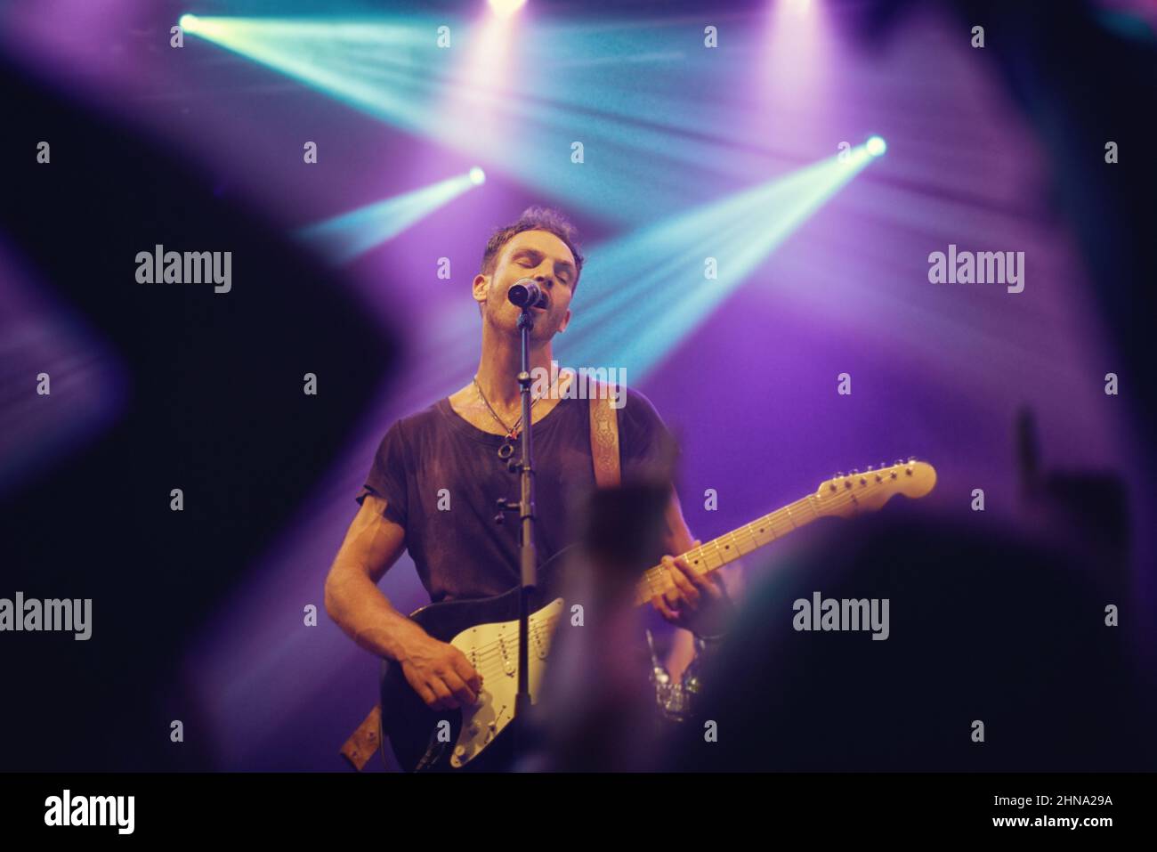 Playing from my soul. Musician playing guitar and singing at a gig. Stock Photo