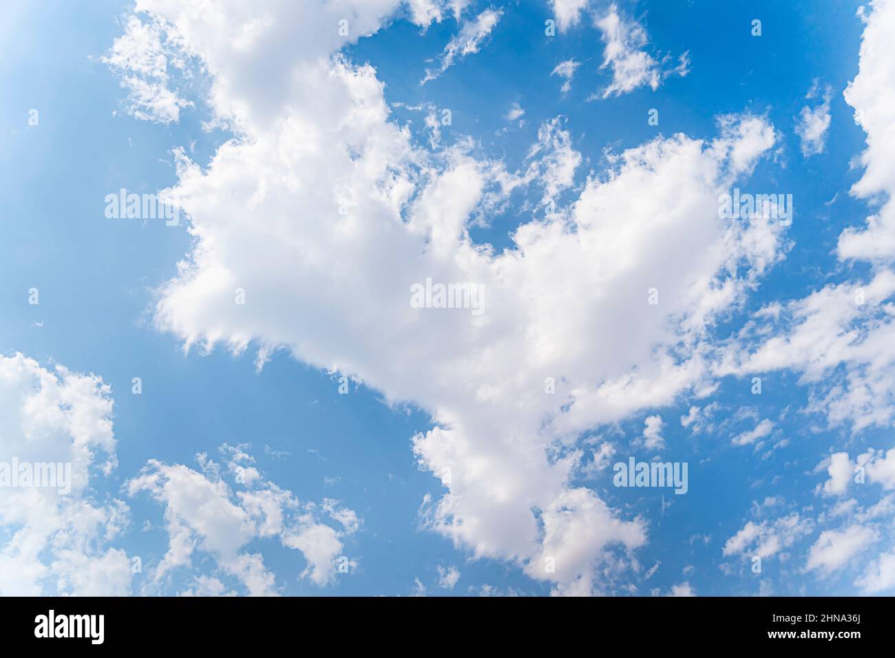 white cumulus clouds in a blue sky. Beautiful natural background Stock Photo