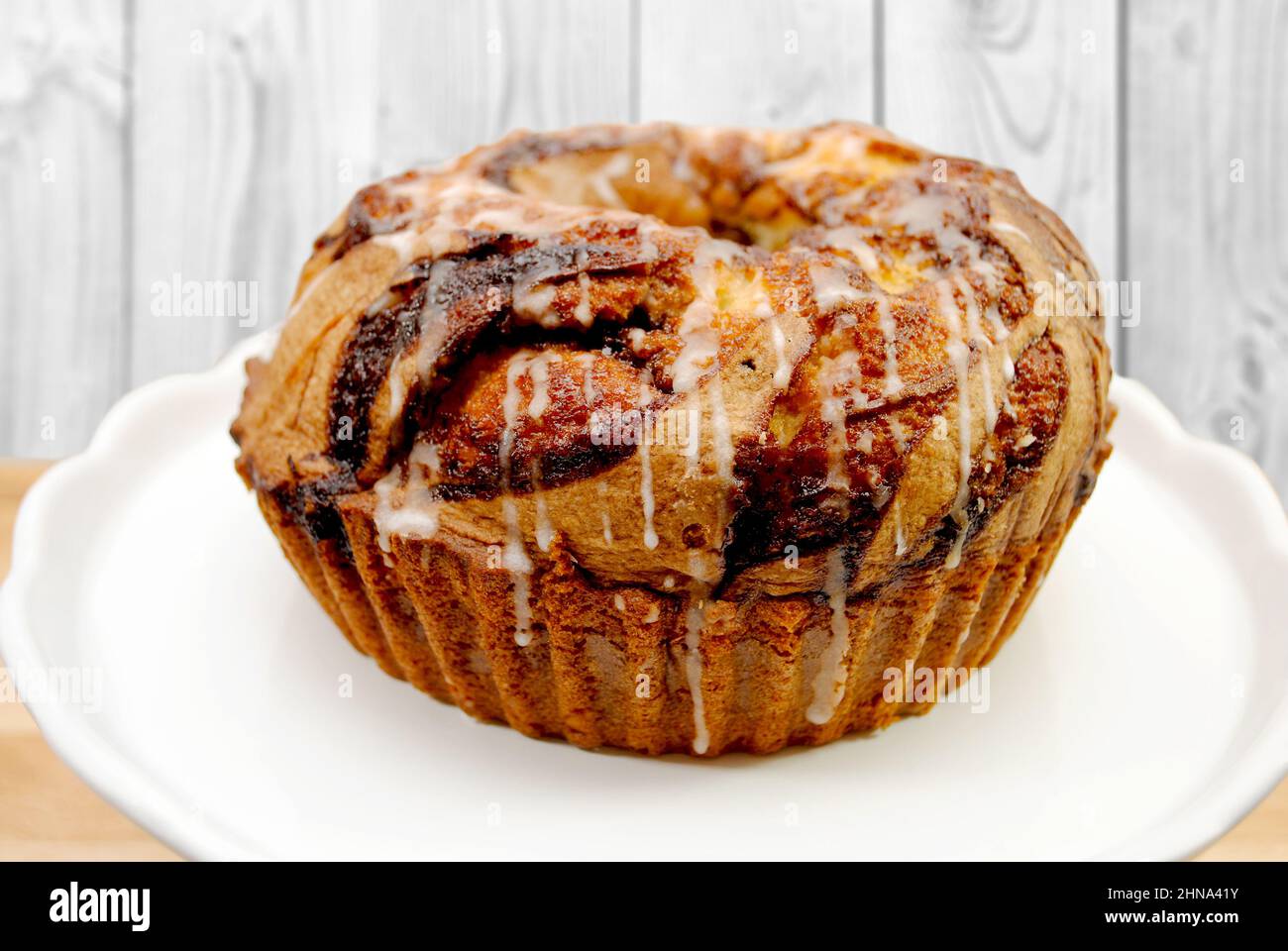 A Marbled Bunt Cake with Glaze Drizzled on Top Stock Photo