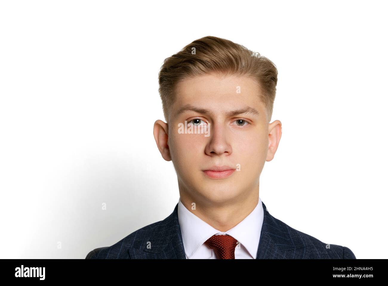 Close-up portrait of handsome young businessman, student, diplomat looking at camera isolated on white studio background. Human emotions, facial Stock Photo