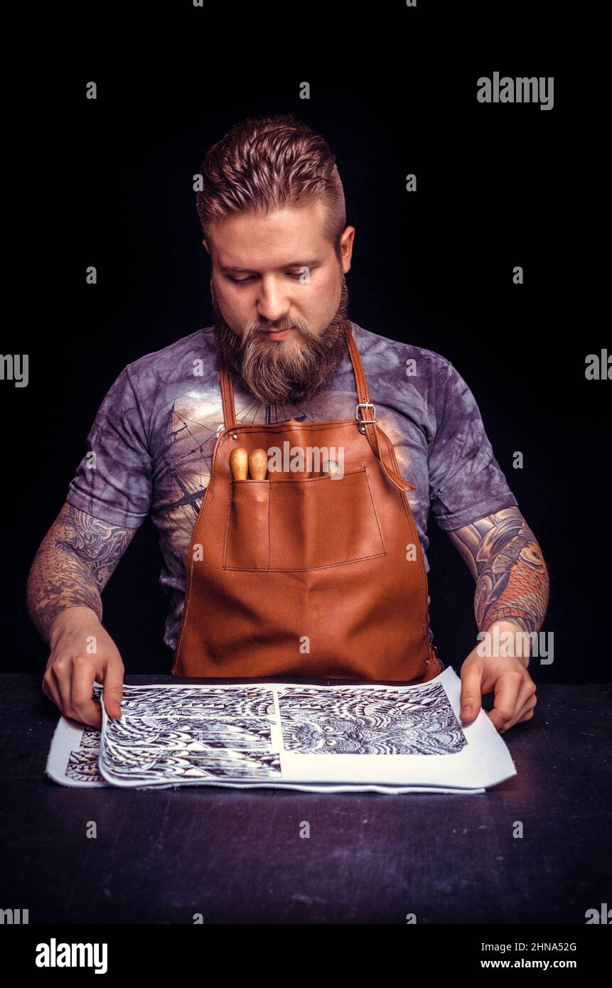 Leather Professional performs leather working for a new product in the work area Stock Photo