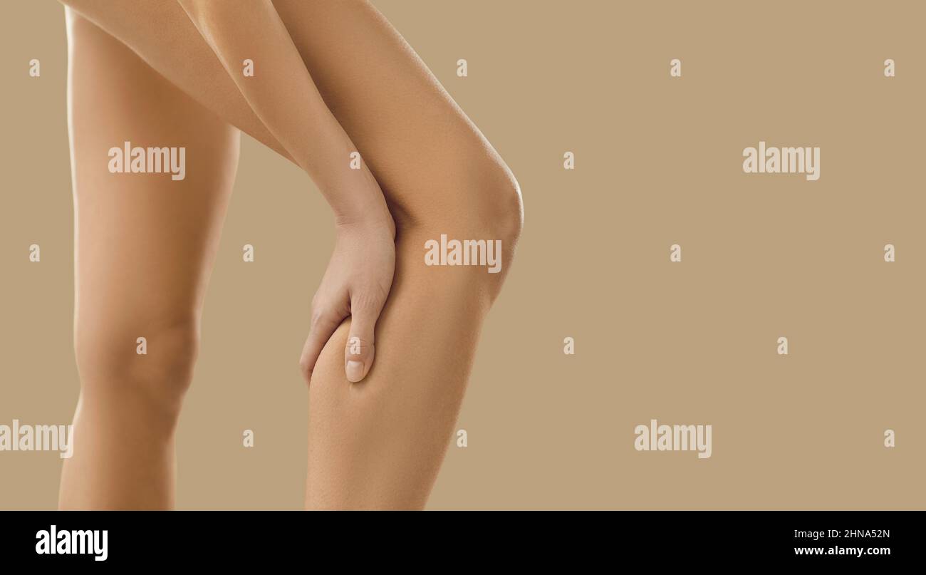 Woman suffer from pain in leg calf Stock Photo