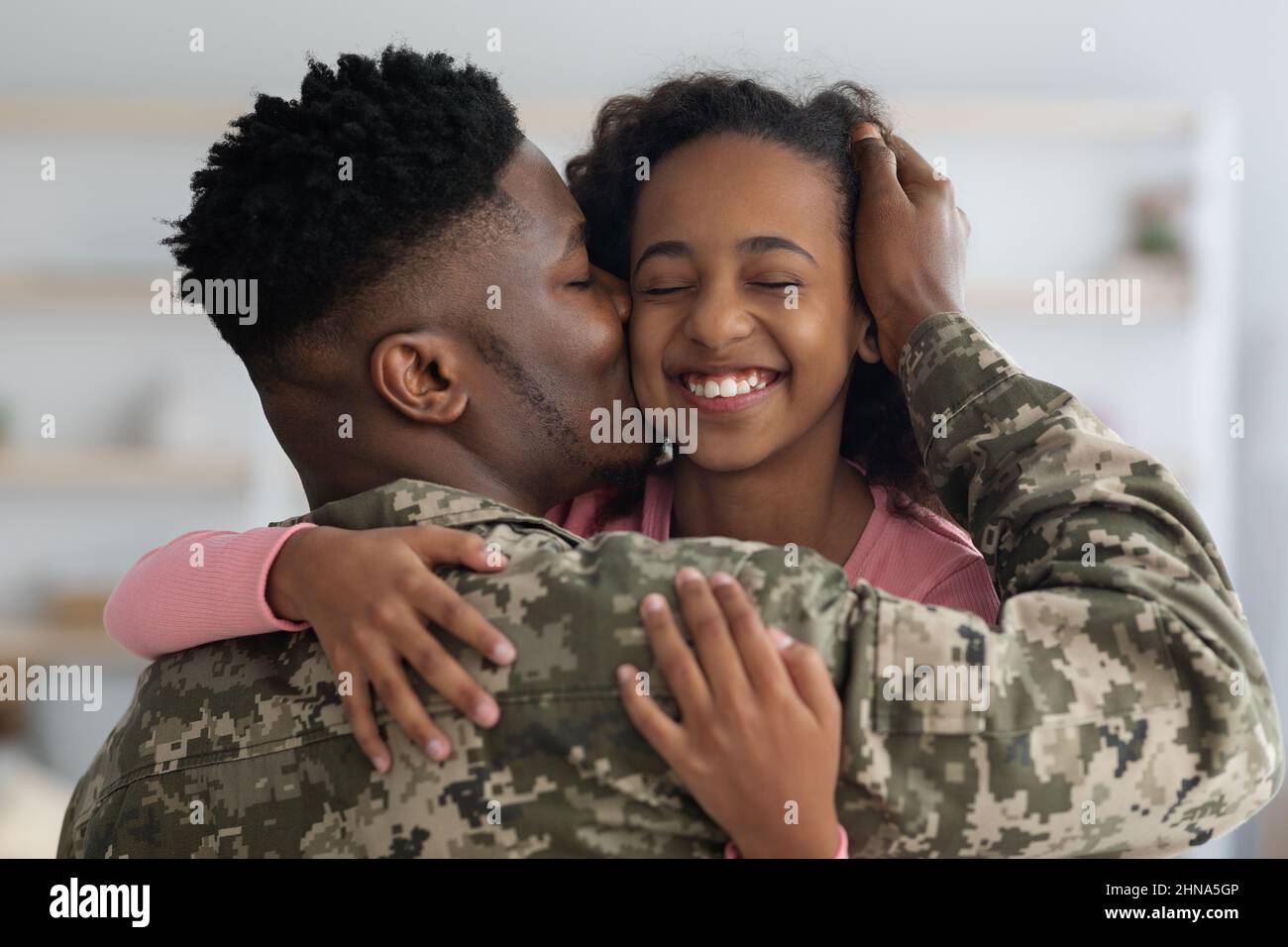 Loving black father in camouflage kissing his daughter Stock Photo Alamy