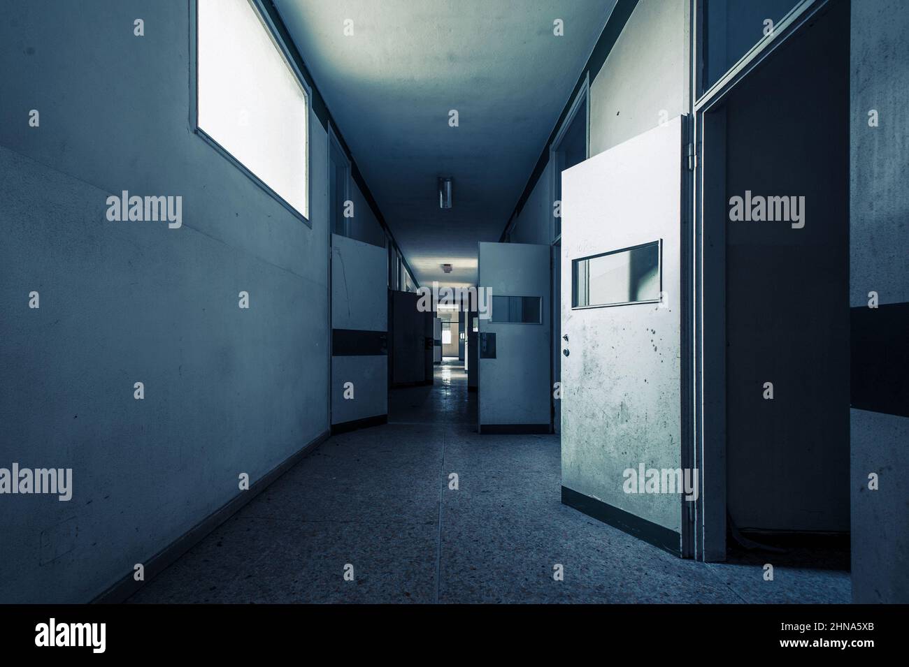 February 2022, disturbing corridor of an abandoned asylum, in Italy Stock Photo
