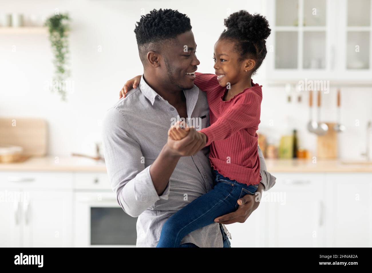 Happy african american father holding his cute little daughter Stock ...