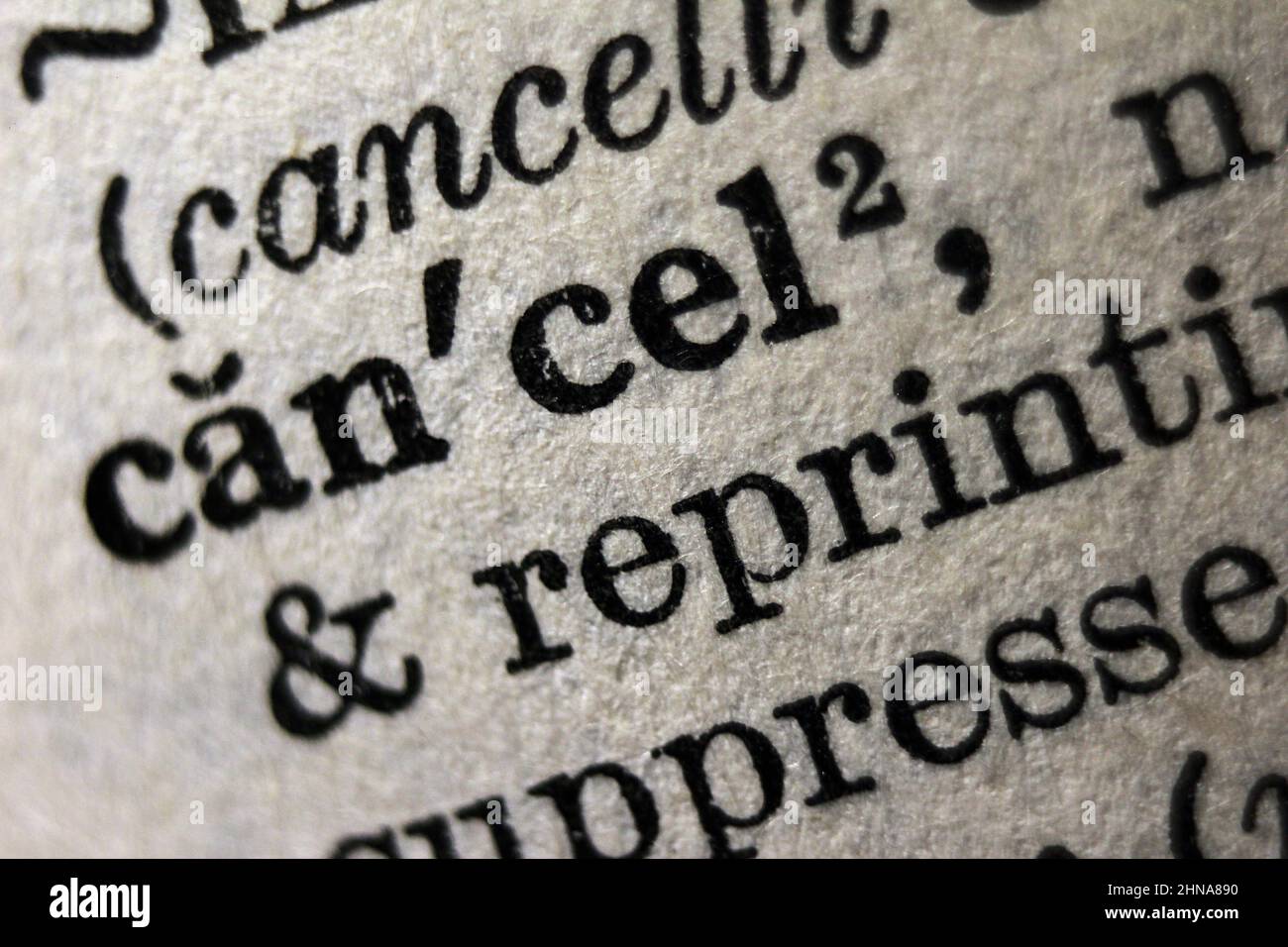 Word 'cancel' printed on dictionary page, macro close-up Stock Photo
