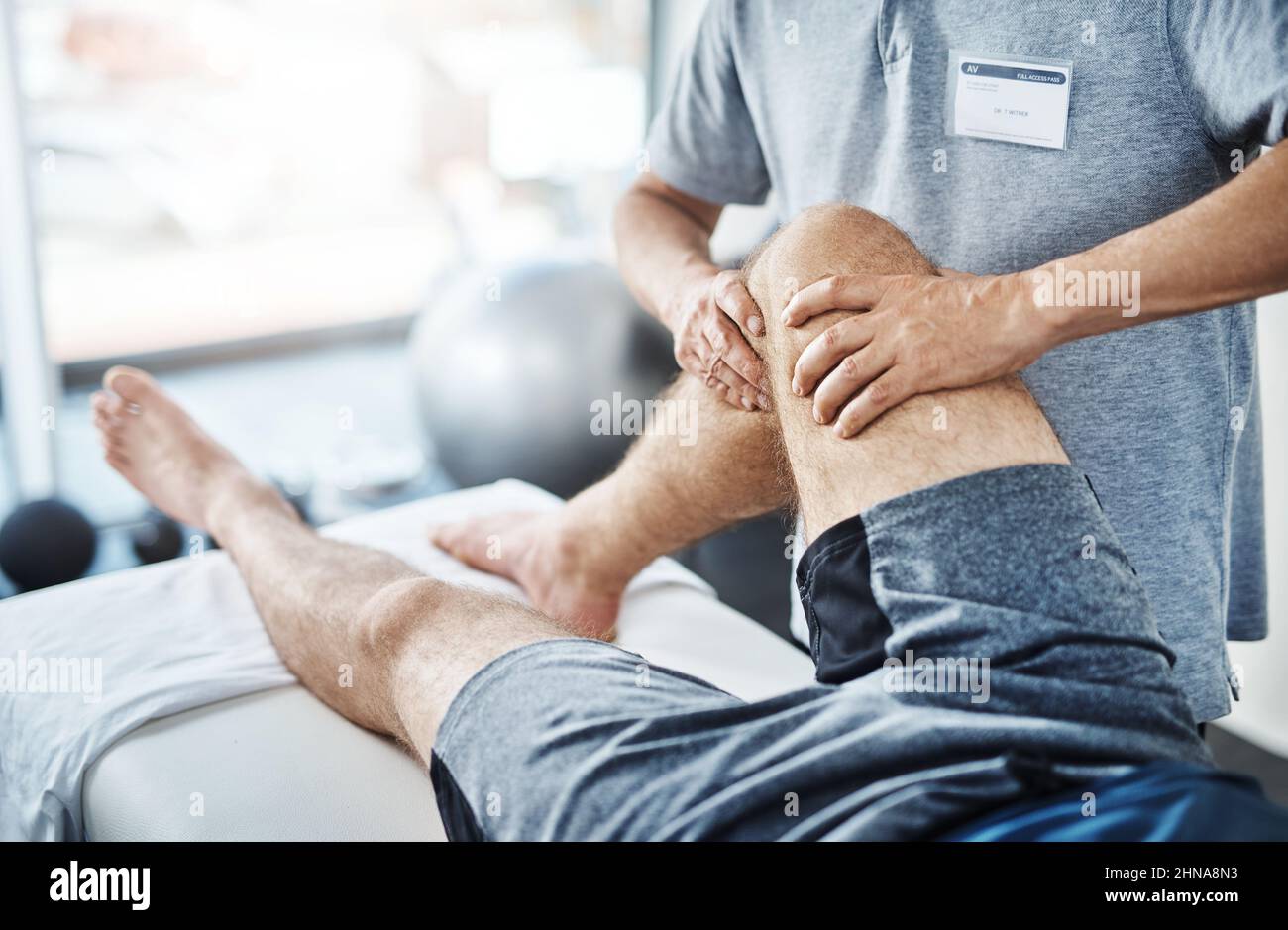 Well sort out these sprains and strains. Closeup shot of an unrecognizable physiotherapist treating a patient. Stock Photo