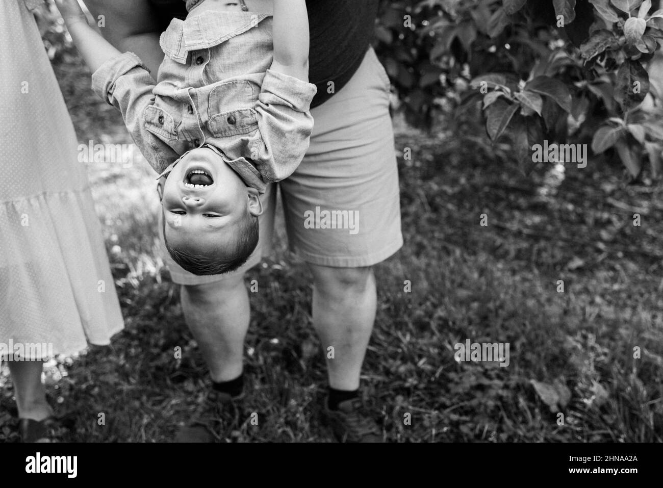 Child held upside down hires stock photography and images Alamy