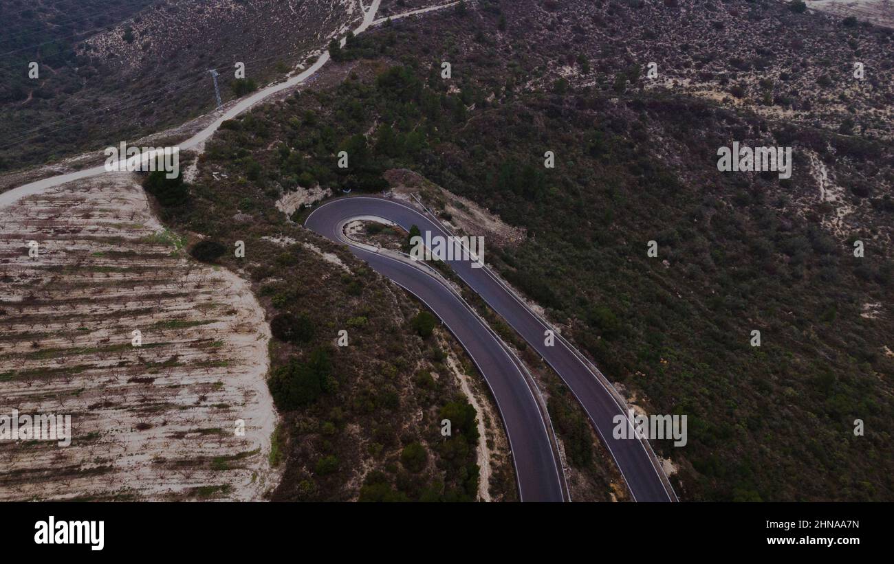 Aerial photo of a curved road in a mountain Stock Photo
