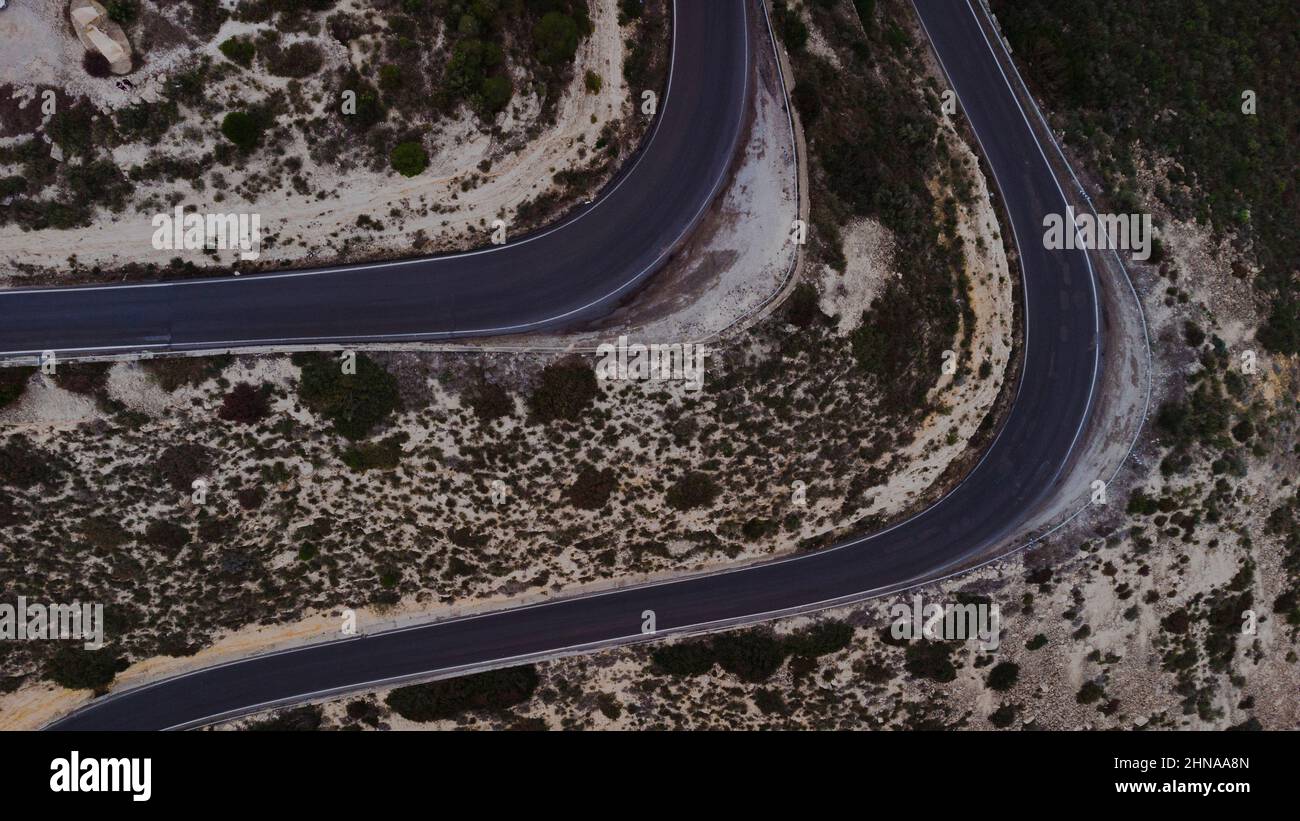 Aerial photo of a curved road in a mountain Stock Photo