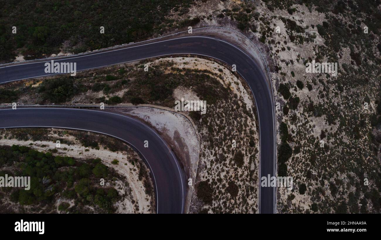 Aerial photo of a curved road in a mountain Stock Photo - Alamy