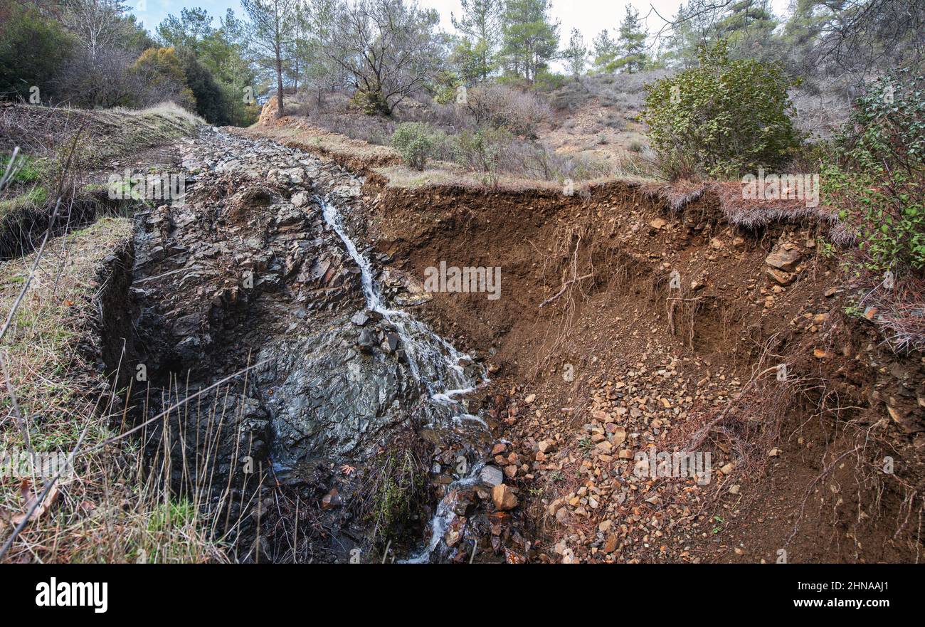 Landslide on a forest road, ground washed out by heavy rainfall Stock Photo