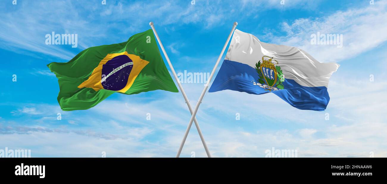 crossed national flags of Brazil and San Marino flag waving in the wind ...