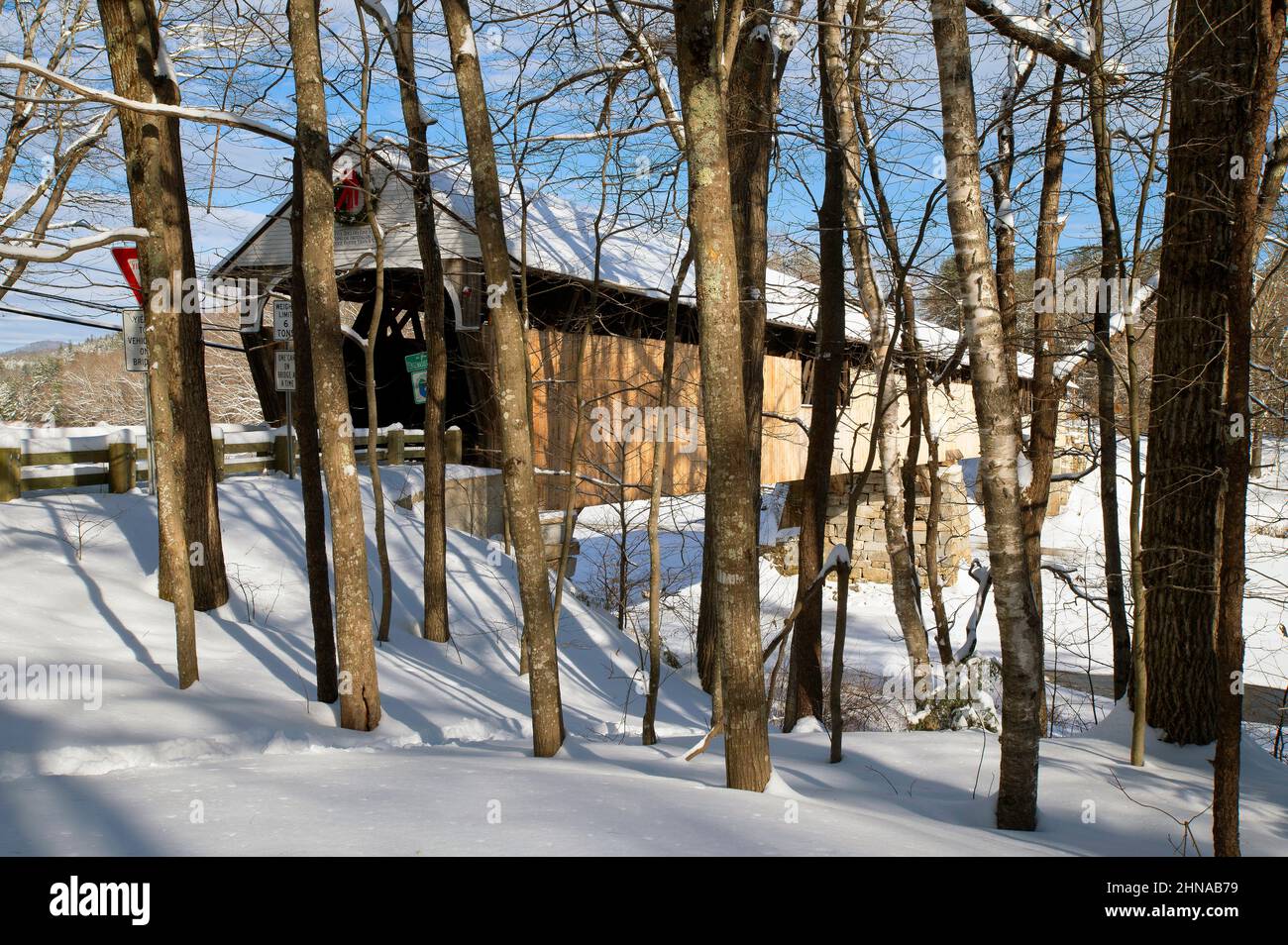 The Blair Covered Bridge as seen through trees (1869) in Campton, New Hampshire, USA on a Winter