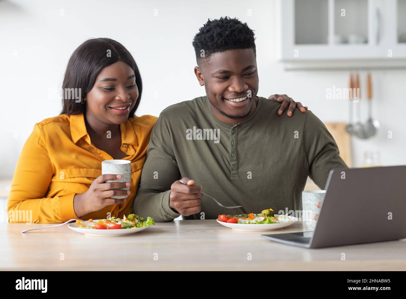 Happy African American Couple Watching Movie On Laptop Computer While