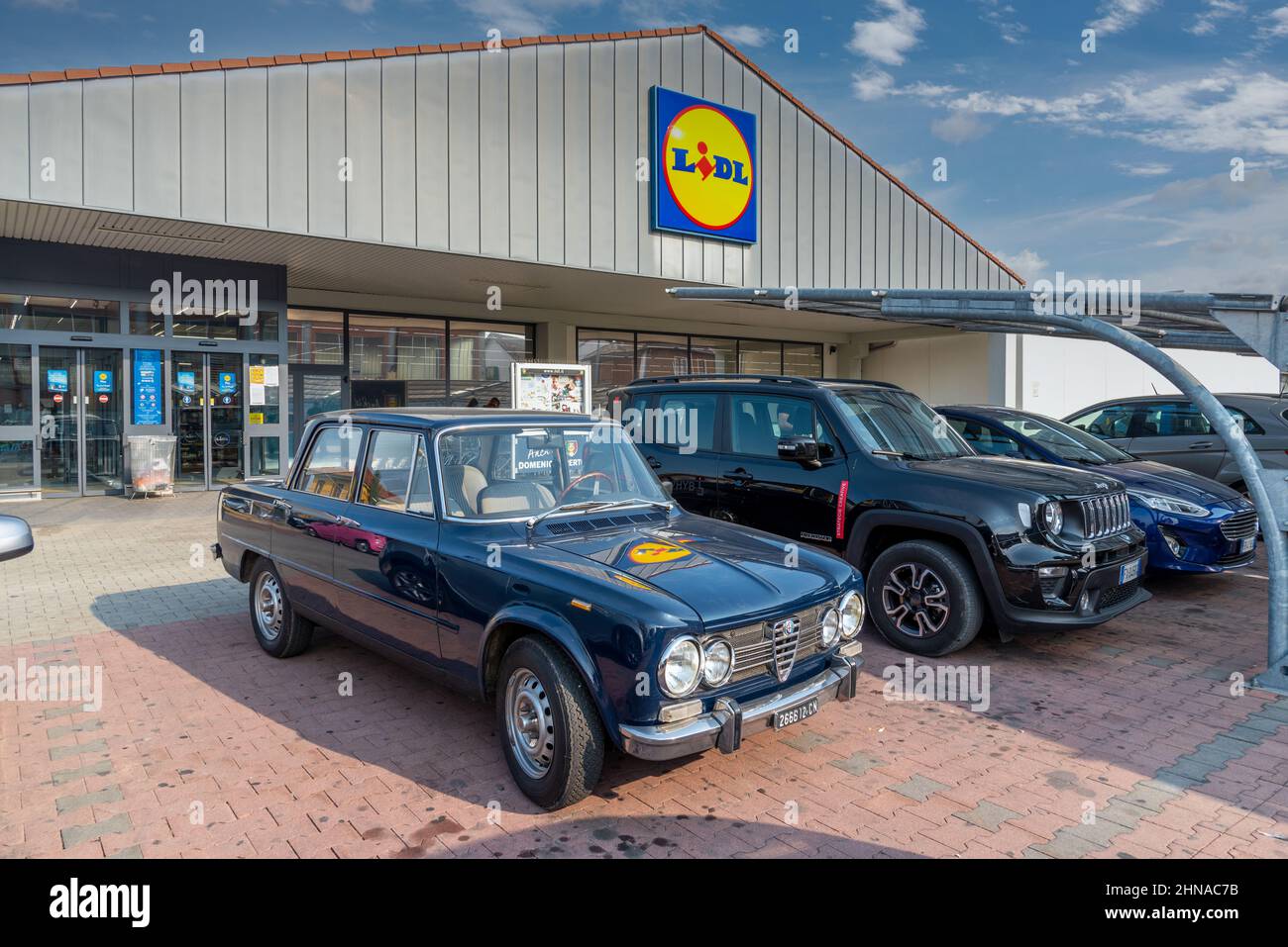 Fossano, Cuneo, Italy - September 9, 2021:  Vintage Alfa Romeo Giulia super 1,3 (70s of 20th century) in the parking lot in front to LIDL supermarket, Stock Photo
