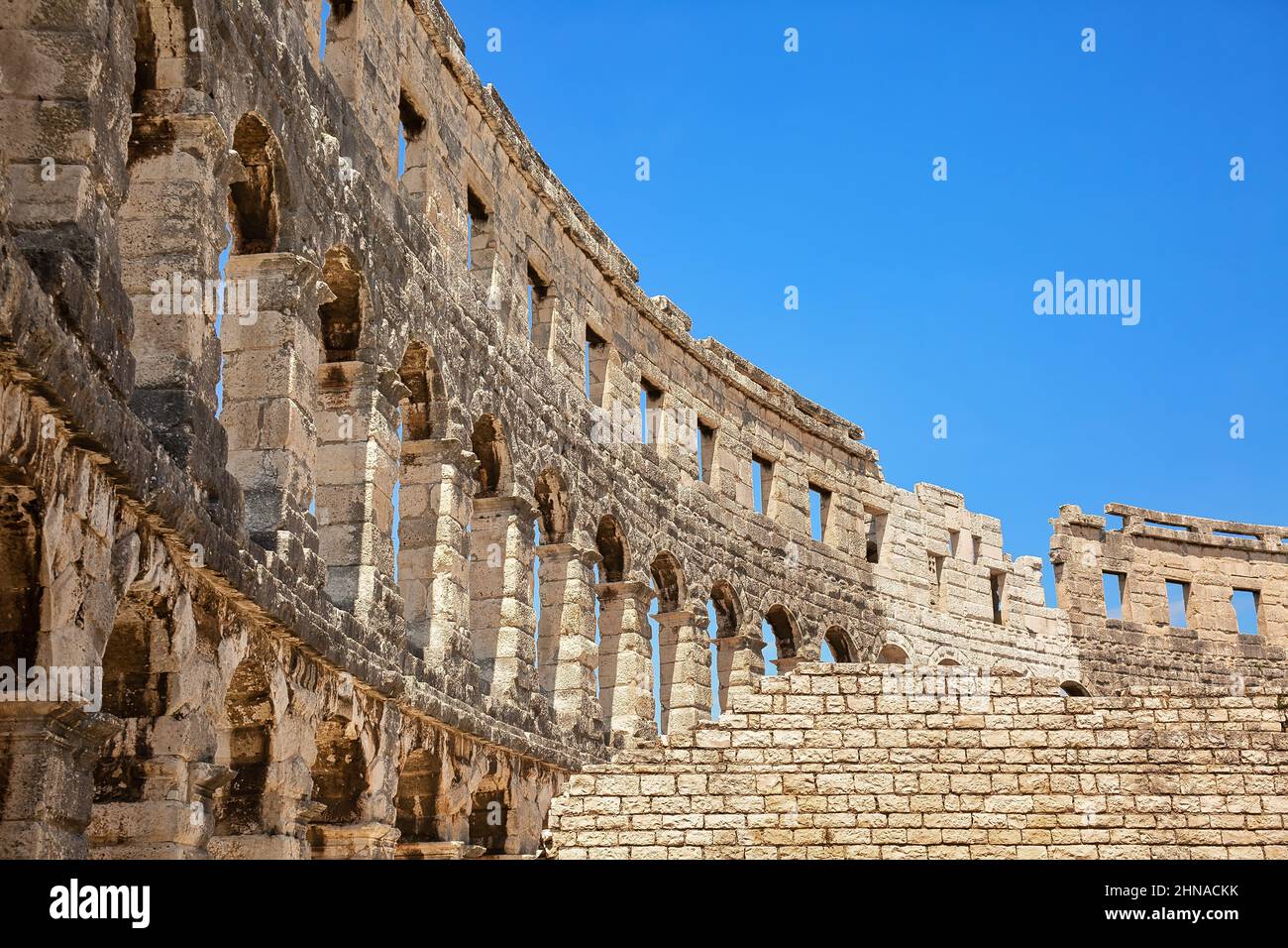 Ancient wall of amphitheater in Pula, Croatia. Historic heritage tourism and travel background Stock Photo