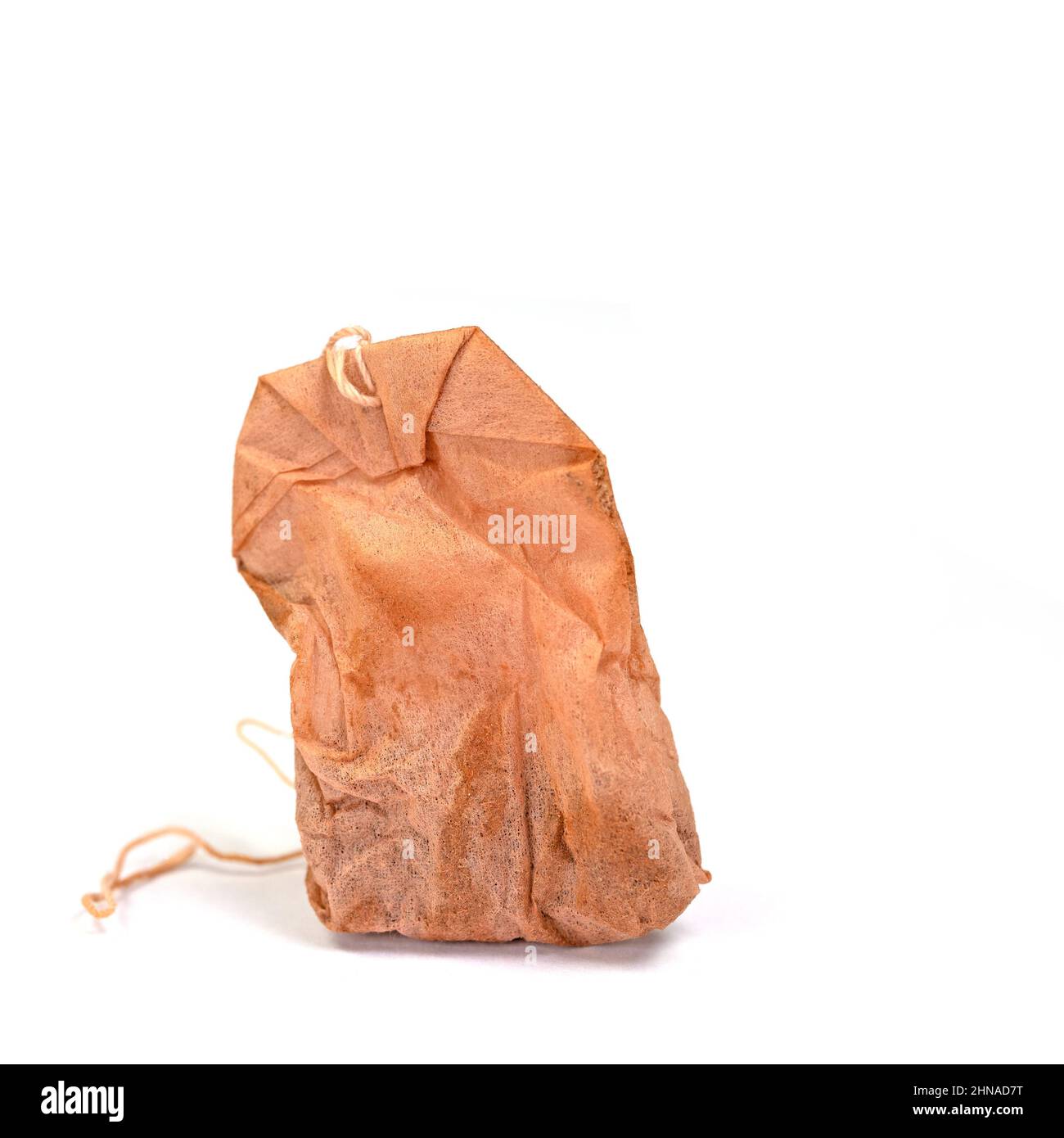 Old tea bag against white background Stock Photo