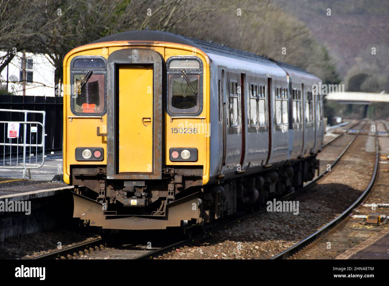 Taffs Well, Wales - February 2022: Local commuter train on the Valley Lines leaving the village railway station in Taffs Well. Stock Photo