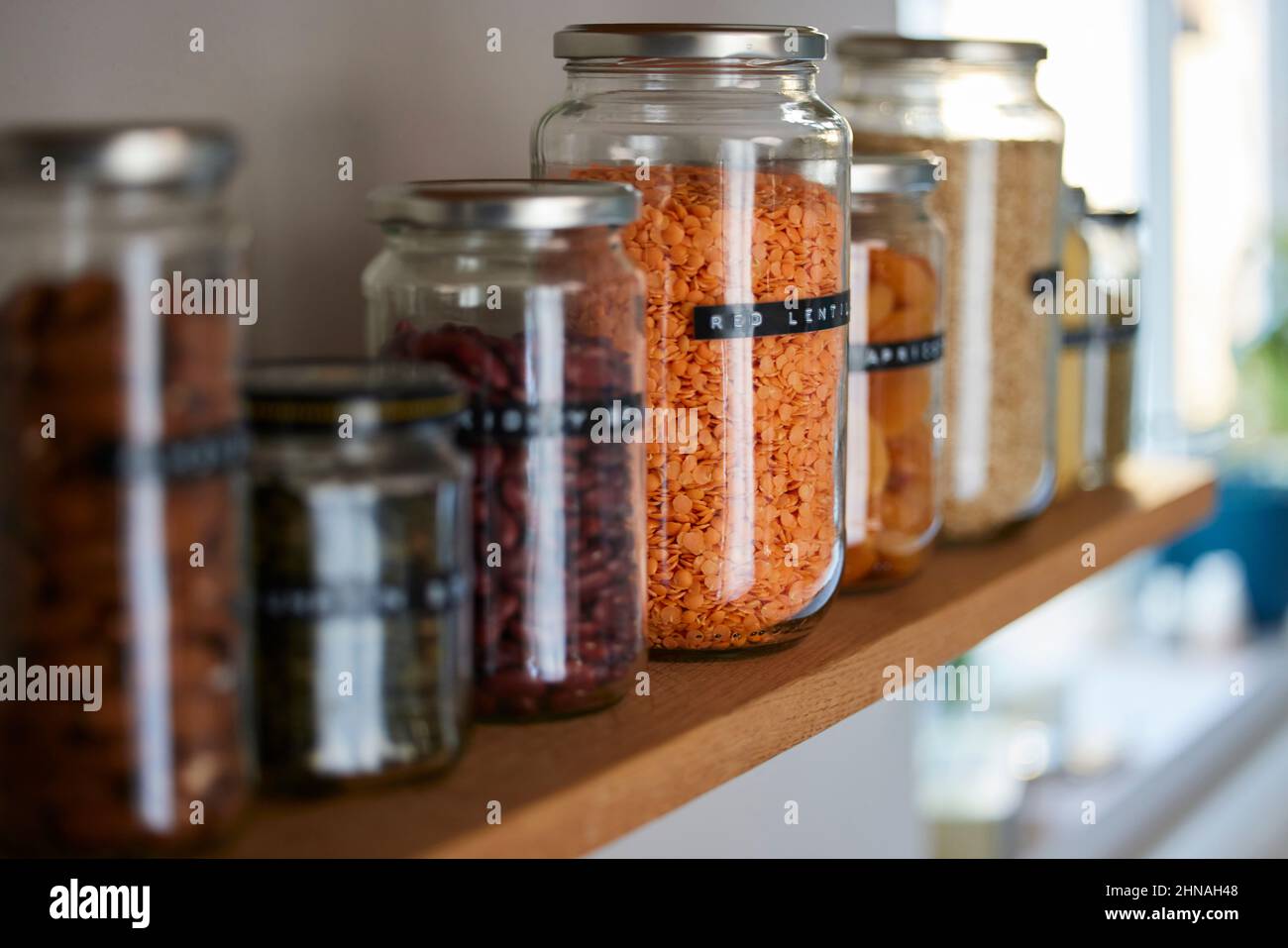 Close Up Of  Glass Jars On Shelf Being Reused To Store Dried Food Living Sustainable Lifestyle At Home Stock Photo