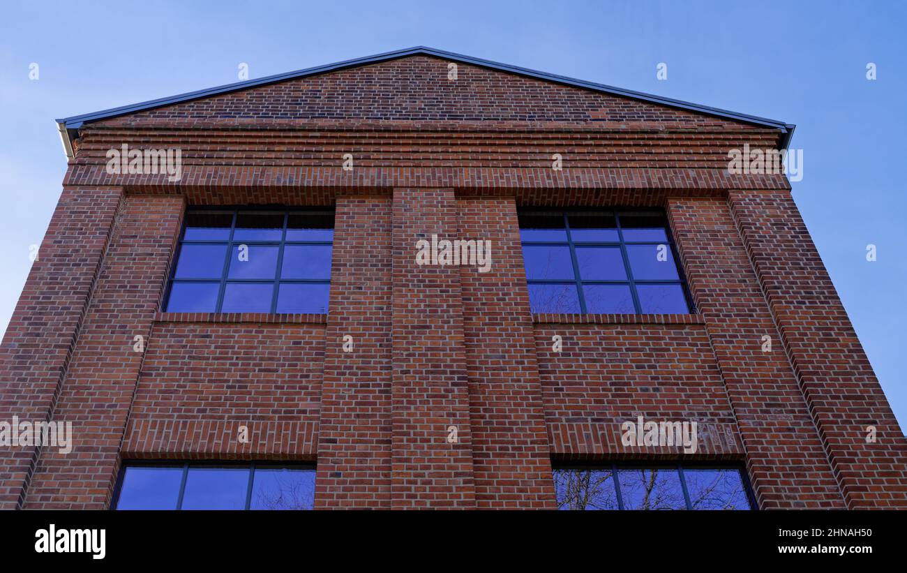 Brick facade under a blue sky Stock Photo - Alamy
