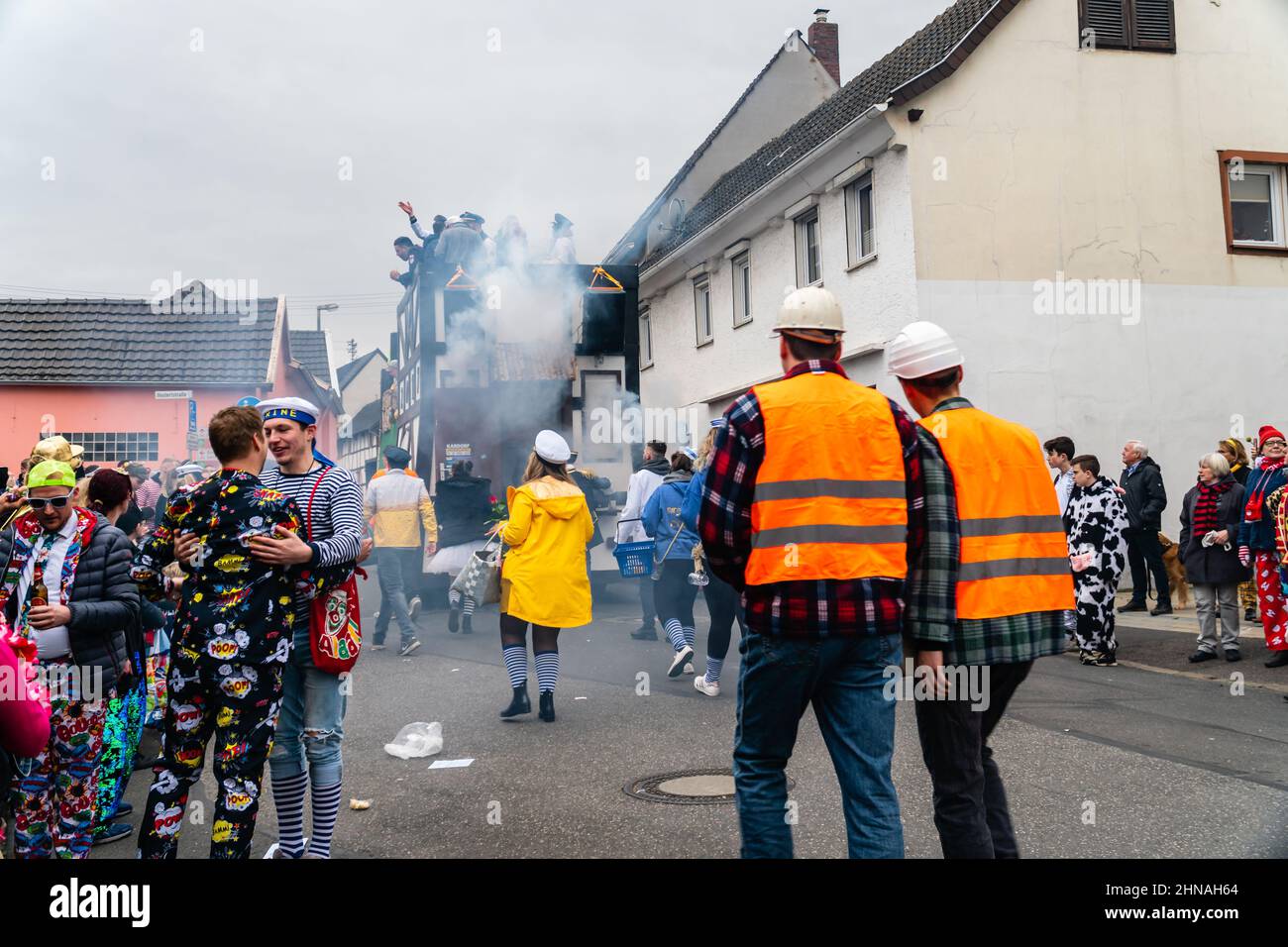 Bornheim, North Rhine-Westphalia, Germany - February 22, 2020: Two men in costumes celebrating friendship during the traditional carnival parade Stock Photo
