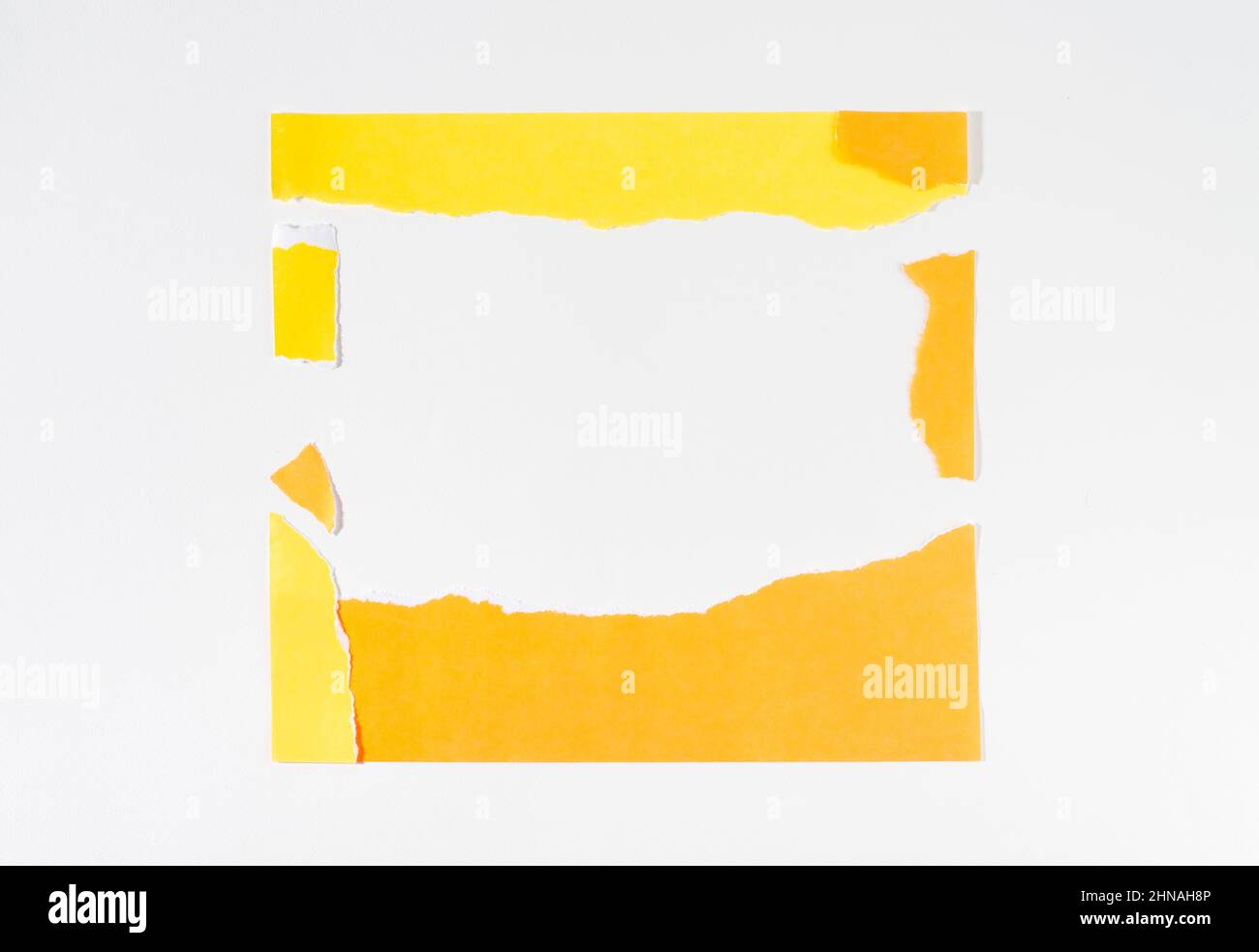 Neon yellow torn paper strip frame on white background. Stock Photo
