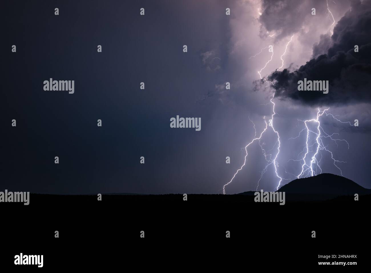 A powerful lightning storm illuminates the night sky near Munds Park, Arizona Stock Photo