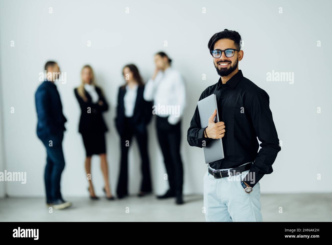 Business man at the office with a group behind him Stock Photo - Alamy