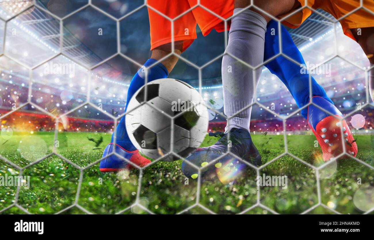 Soccer player kicks the ball to reach the goal Stock Photo