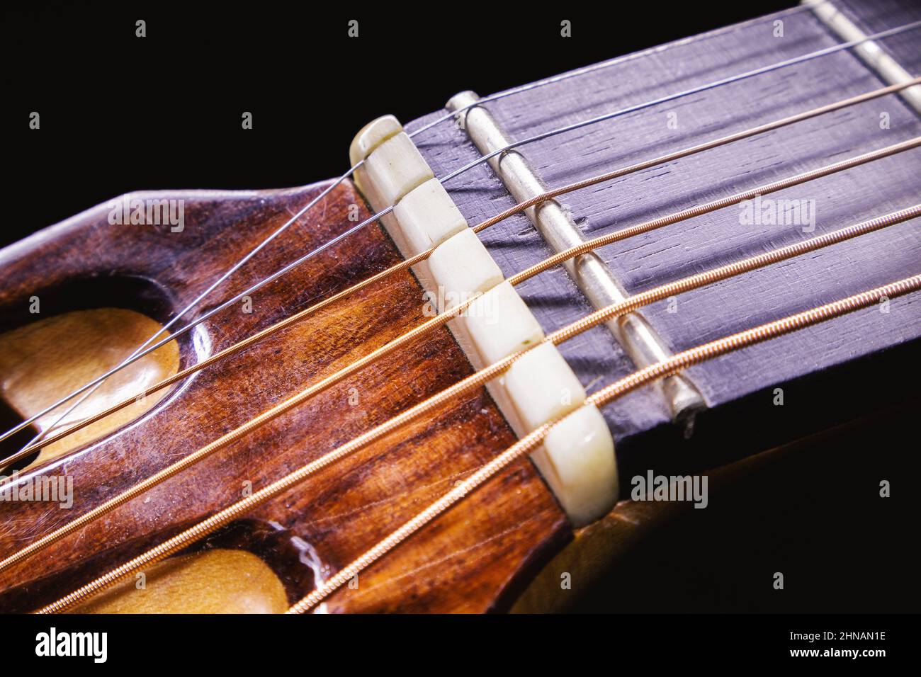 Details of a zero fret on acoustic guitar, closeup view. Stock Photo