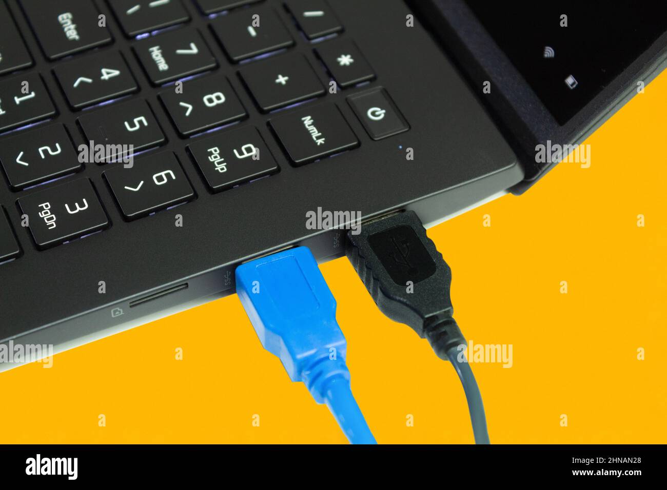 Connecting computers and laptops to the using USB cables. Yellow background with place