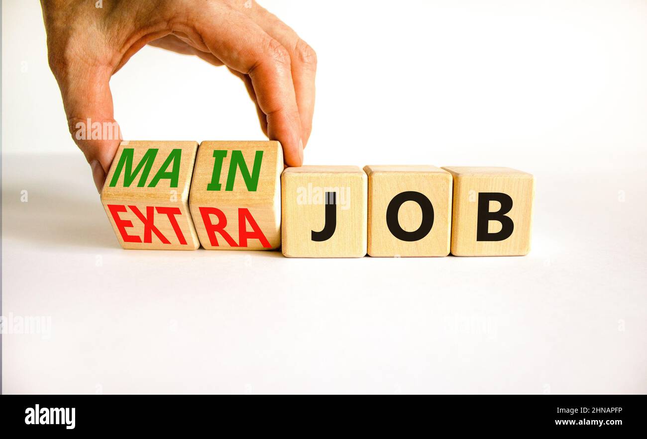 Extra or main job symbol. Businessman turns wooden cubes and changes ...
