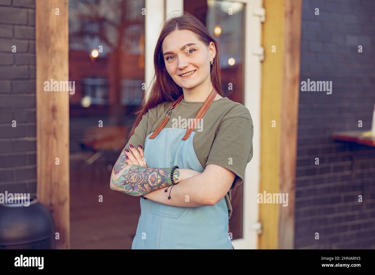 Female worker apron standing hi-res stock photography and images - Alamy