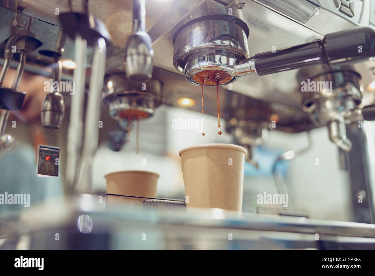 Close-up of espresso machine and shot glasses during a pour Stock Photo -  Alamy