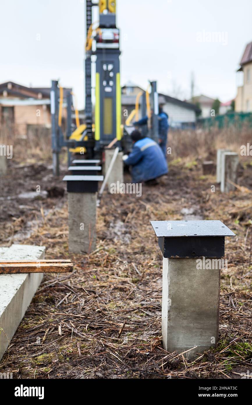Driven cast-in-place piles with steel top or head, foundation for wooden frame house, ground works Stock Photo